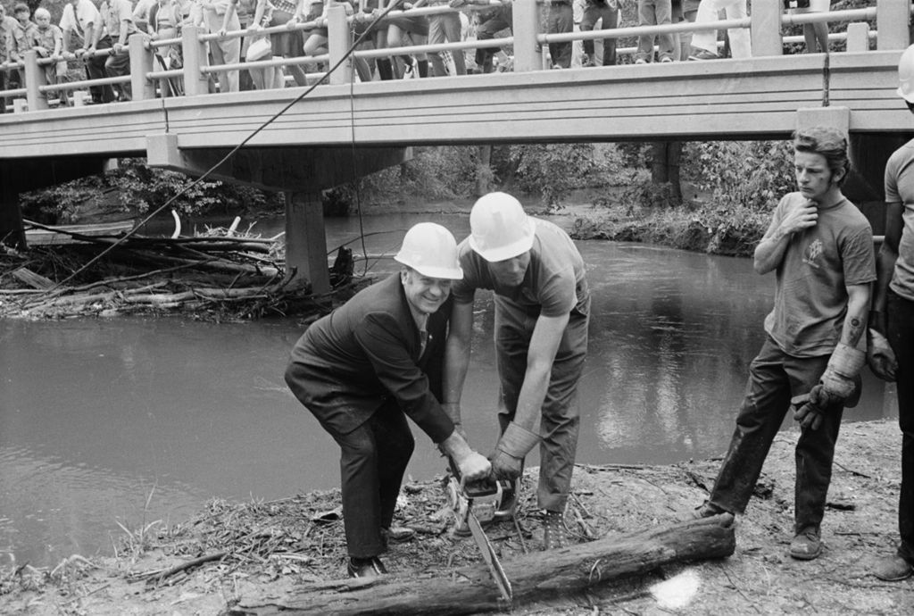 Miniature of Congressman Frank Annunzio with a power saw at the river cleanup