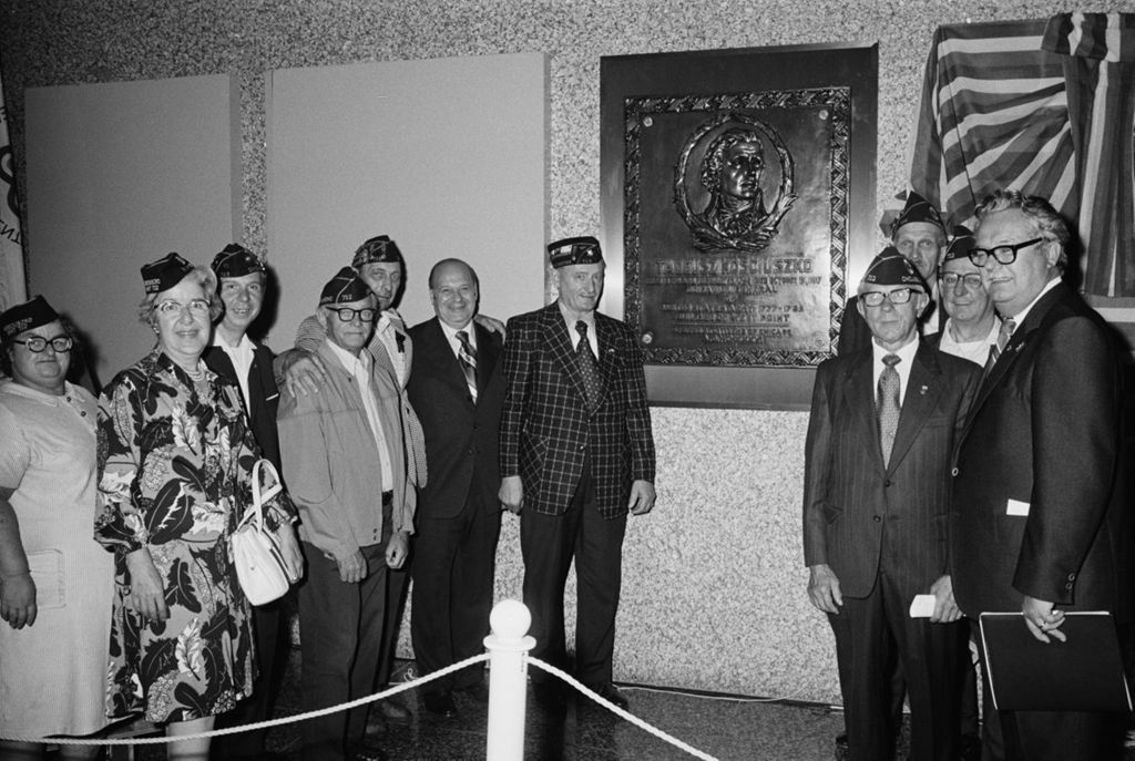 Annunzio with veterans in front of plaque in Dirsken Federal Building