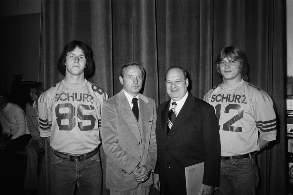 Miniature of Congressman Frank Annunzio at Carl Schurz High School with Principal and football players