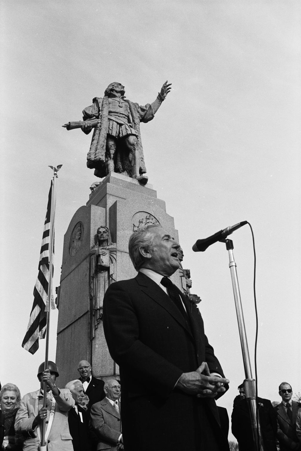 Miniature of Congressman and Parade Chairman Peter Rodino speaks in front of Columbus Monument