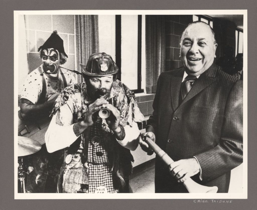 Richard J. Daley with clowns playing musical instruments
