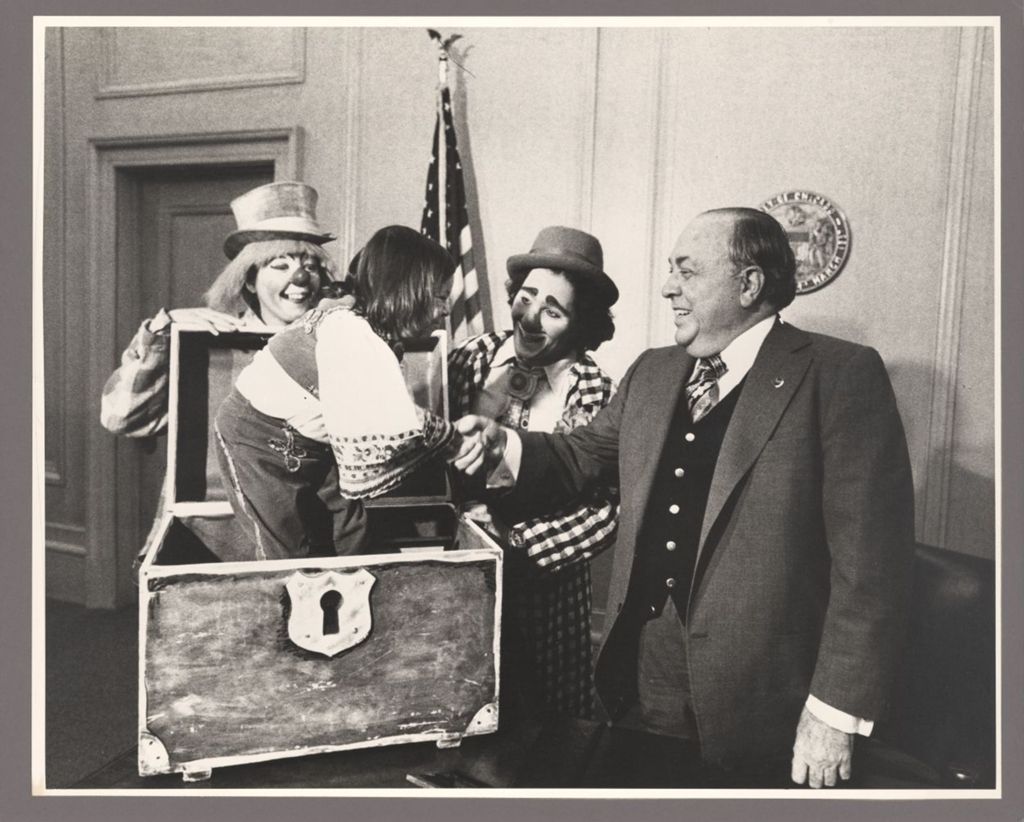 Richard J. Daley in his office with three clowns