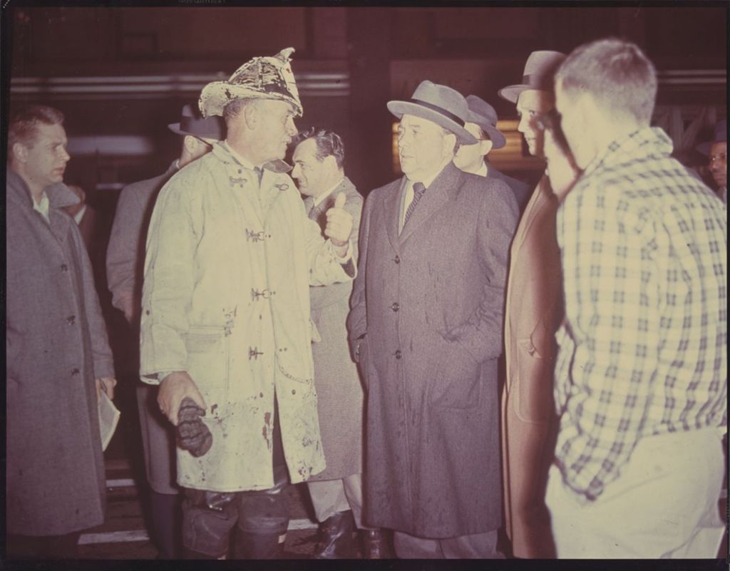 Richard J. Daley speaking with a firefighter