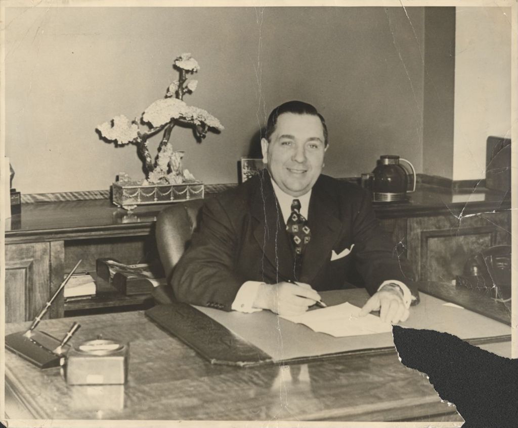 Richard J. Daley, State Director of Revenue, at a desk