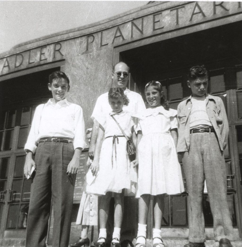 Children and man outside the Adler Planetarium