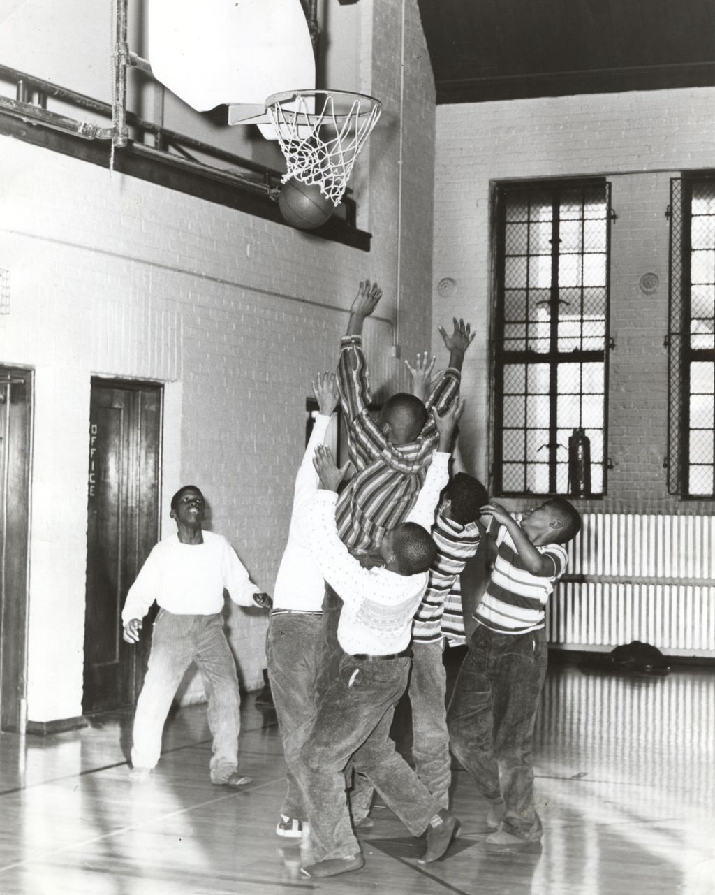 Boys playing basketball in a gymnasium, Marcy Center