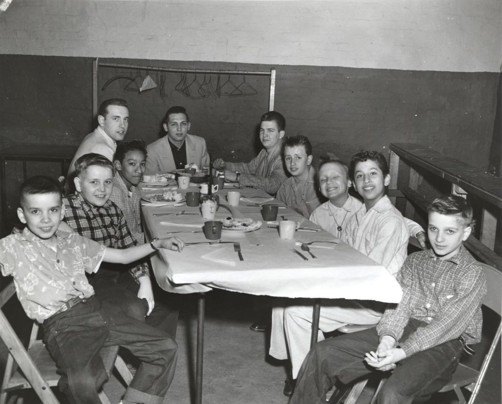 Boys seated at a dinner table