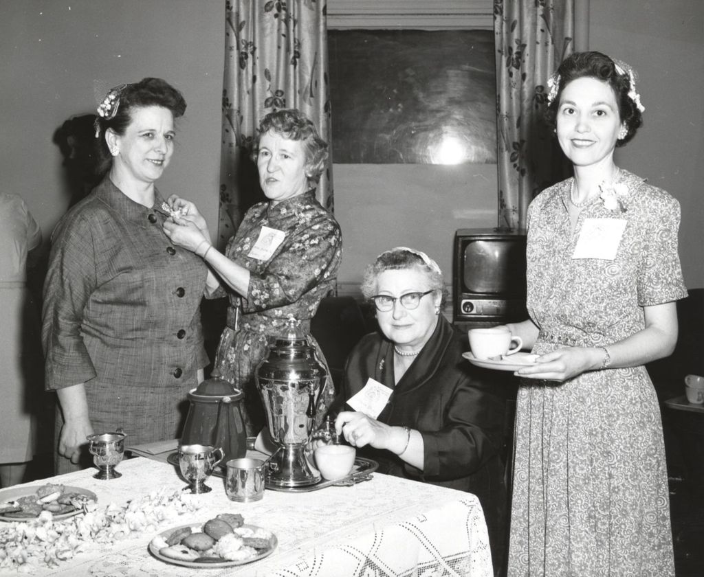 Women at event with coffee and dessert