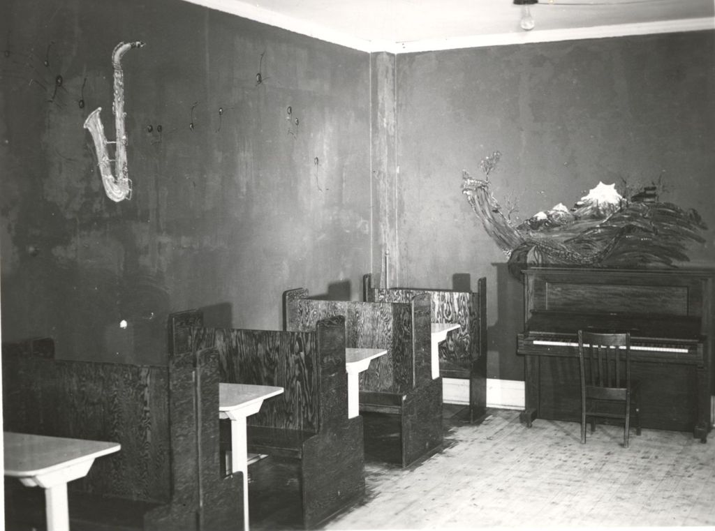 Room with booth tables and piano