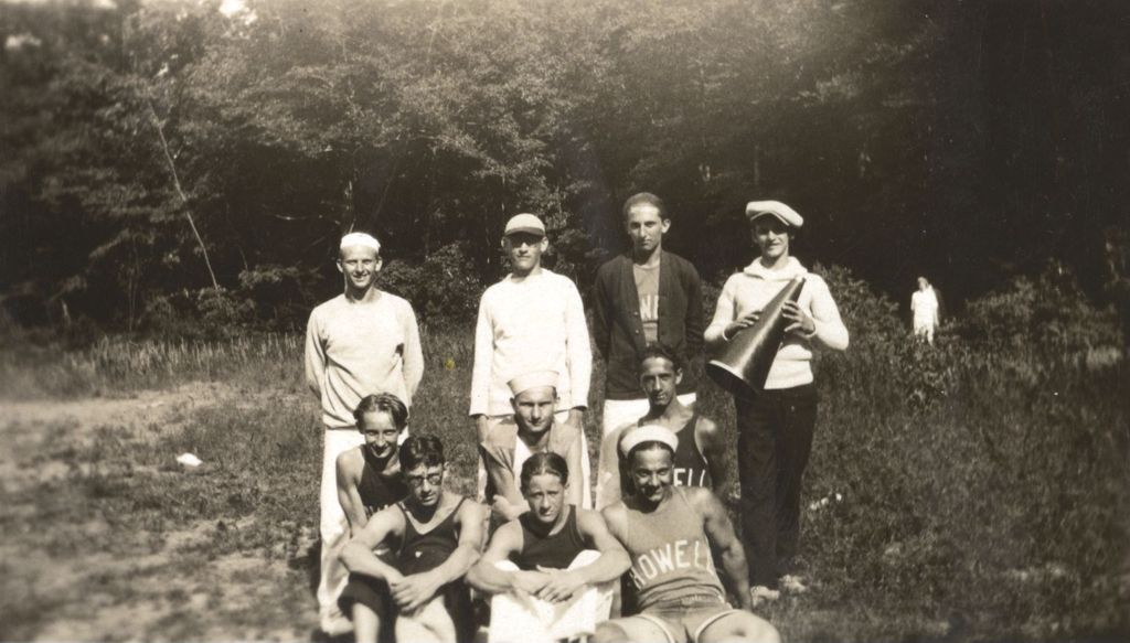 Young men in athletic apparel near a woods