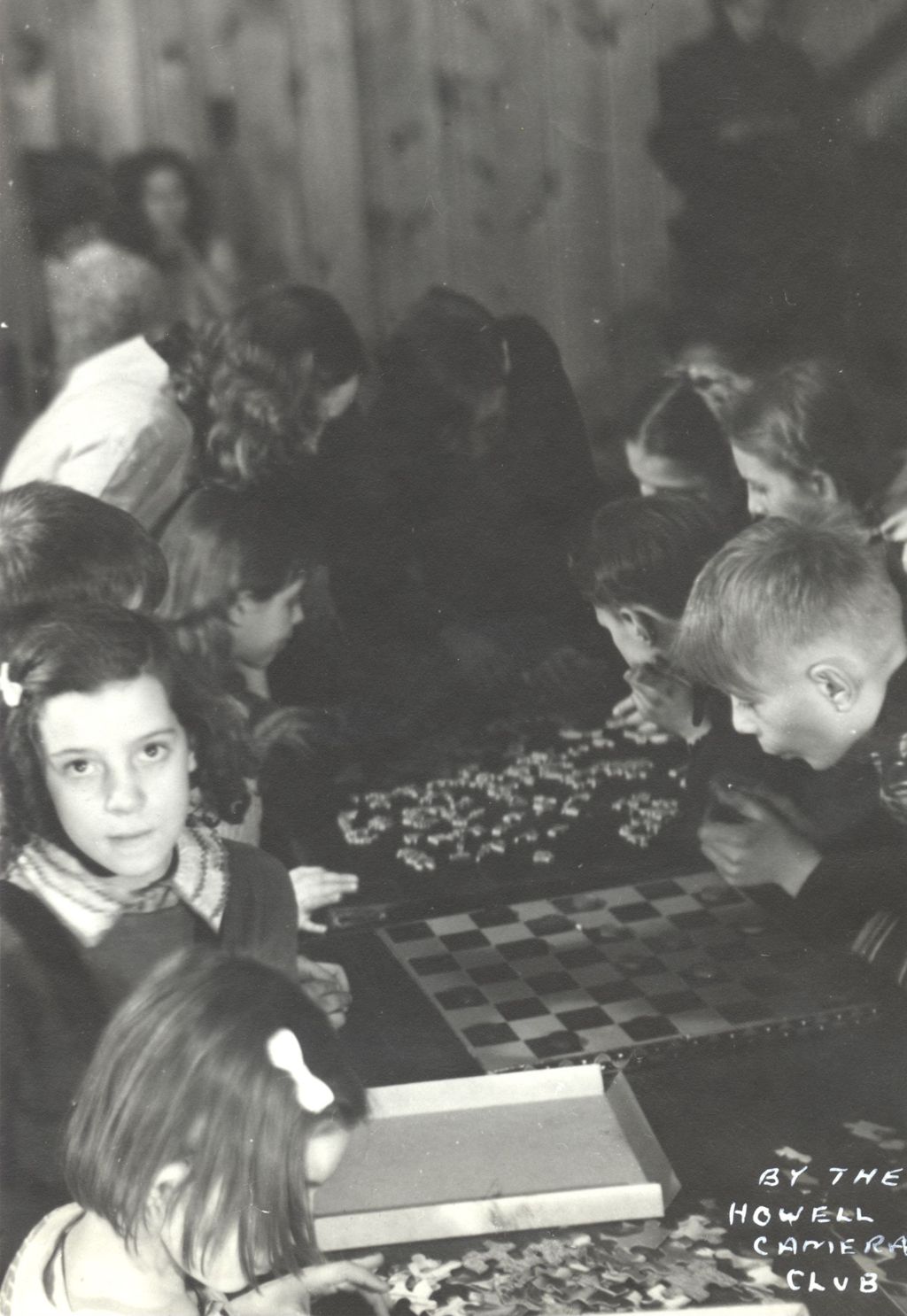 Children playing checkers and doing puzzles