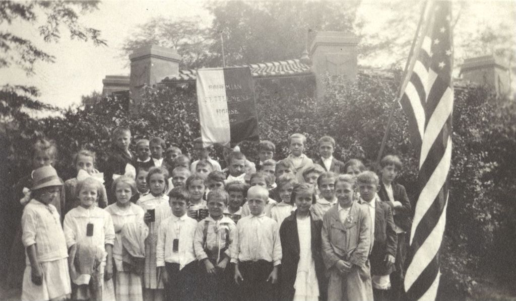 Children with Bohemian Settlement House banner and flag