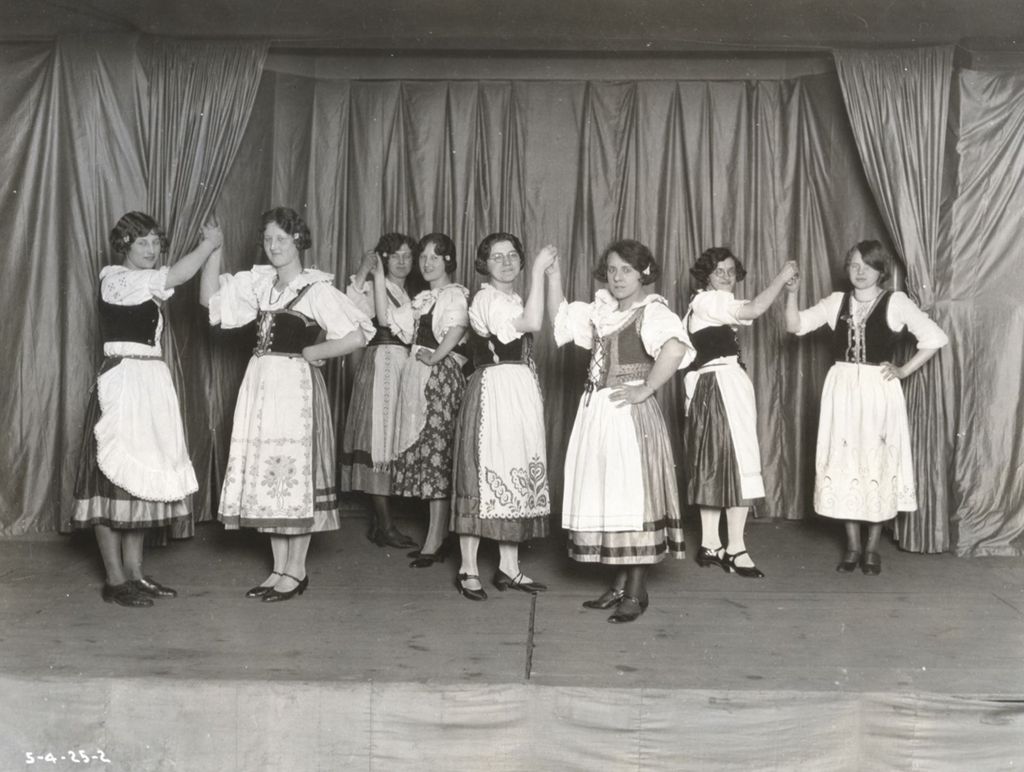 Young women in Bohemian folk costumes in dancing formation