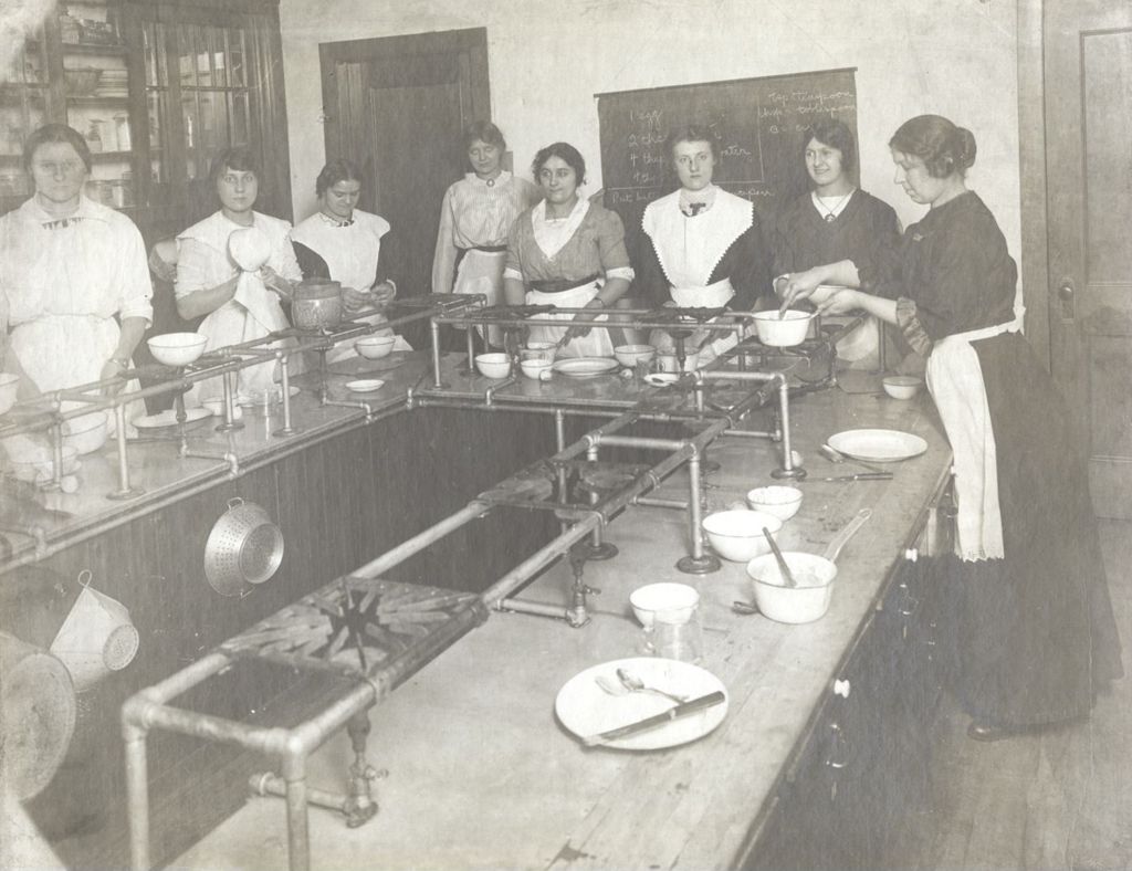 Young women preparing food in kitchen