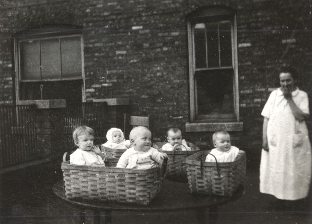 Woman with several babies in baskets