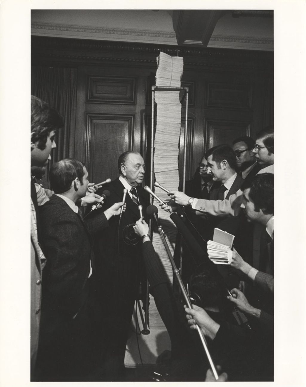 Miniature of Richard J. Daley displaying nominating petitions to reporters