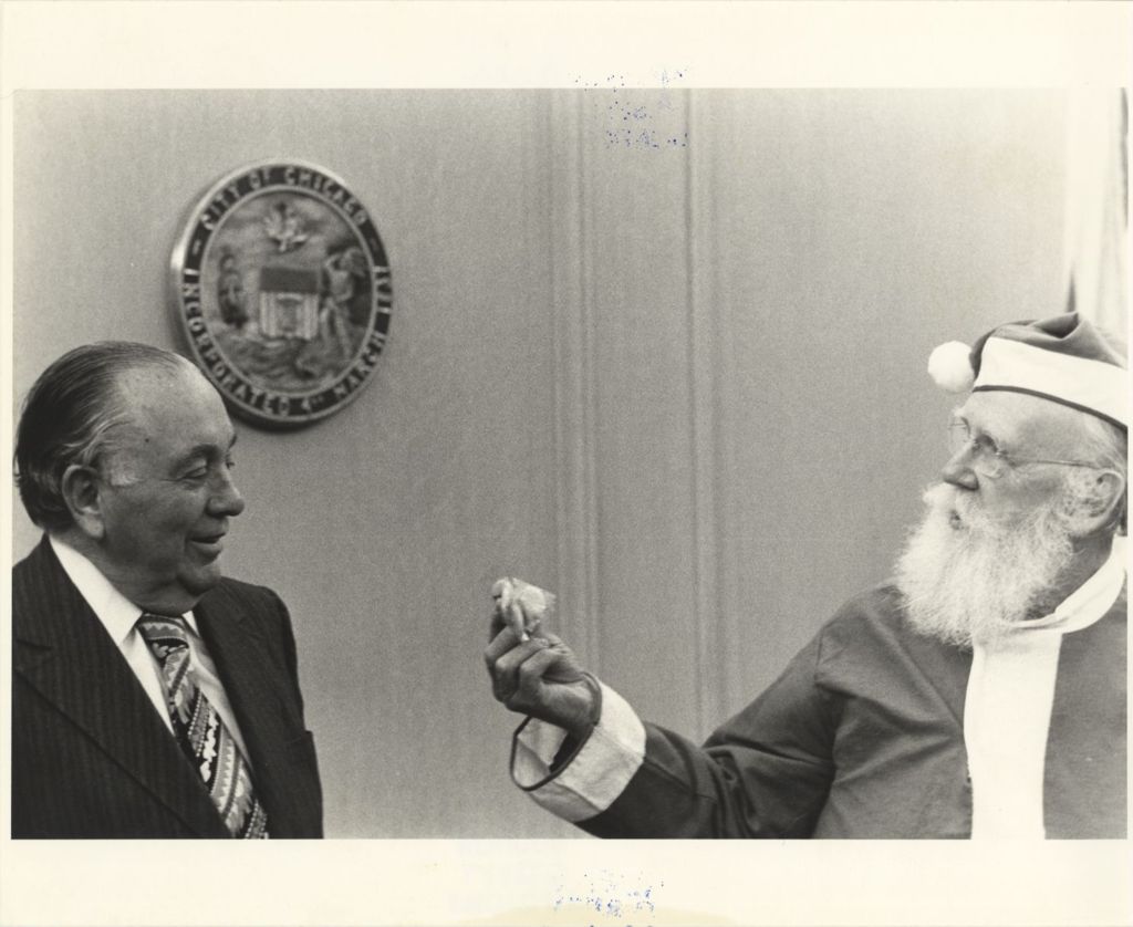 Miniature of Richard J. Daley accepting candy from Santa Claus