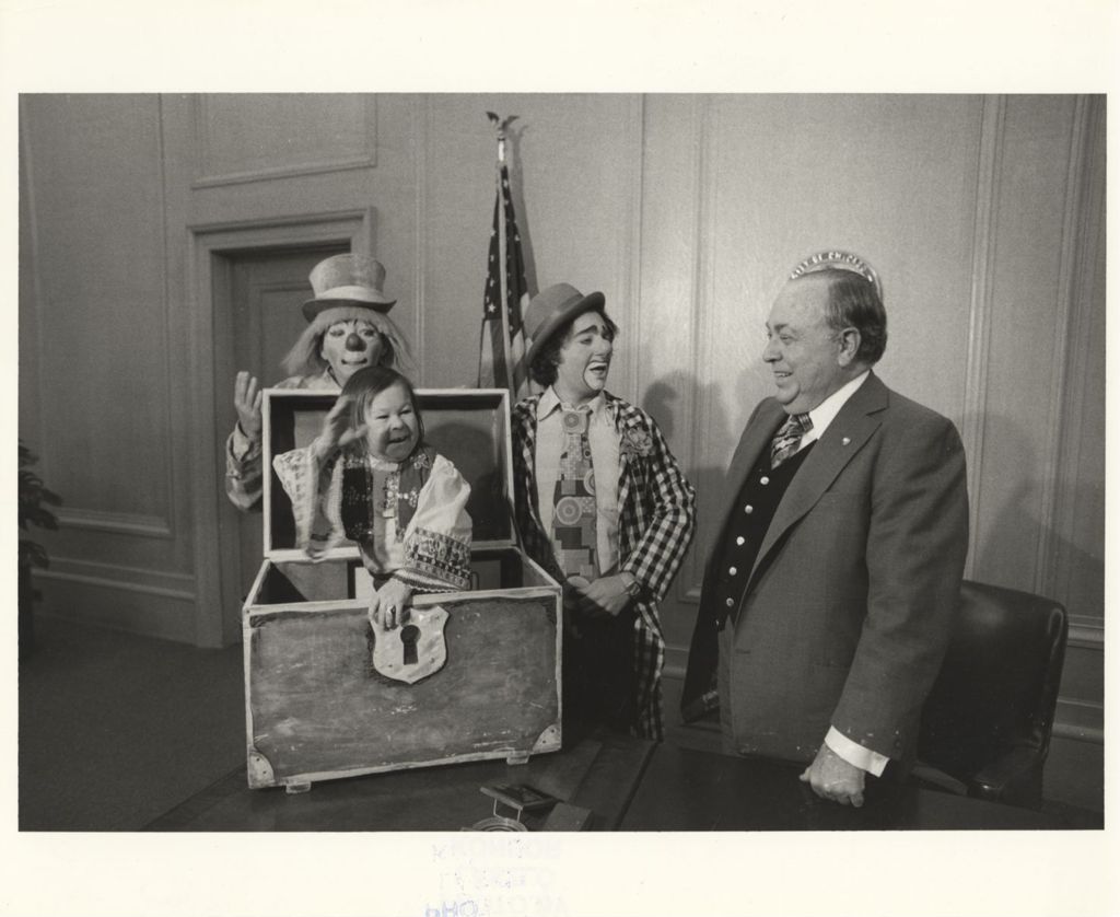 Richard J. Daley in his office with three clowns