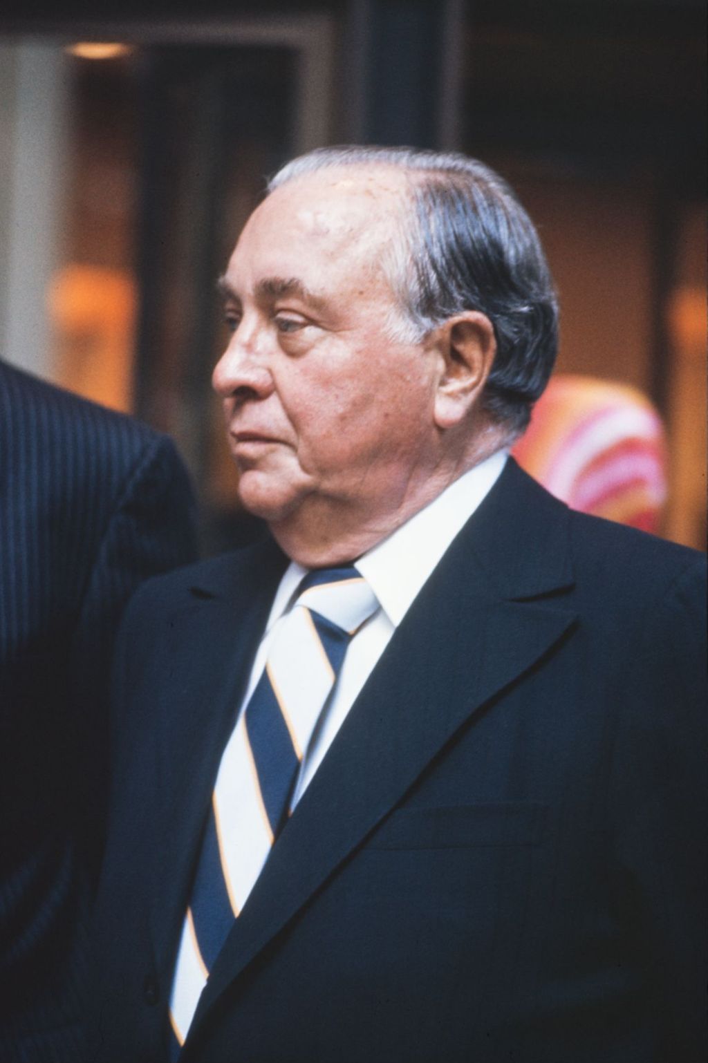 Portraits of Richard J. Daley wearing a navy and white striped tie