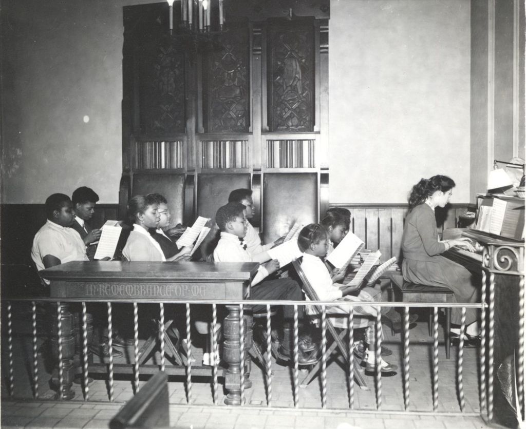 Children in Marcy Chapel singing from sheet music