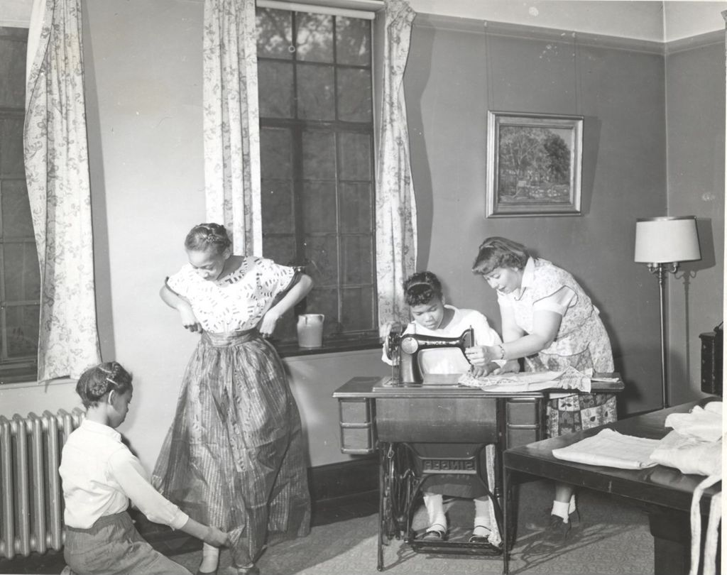 Women and teenage girls working on sewing projects