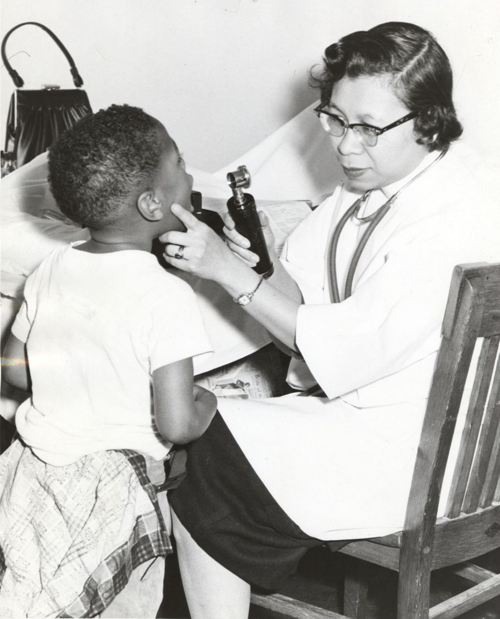 Doctor examining a young boy