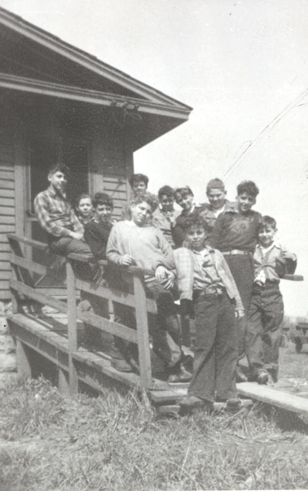 Teenage boys on a ramp outside a camp building