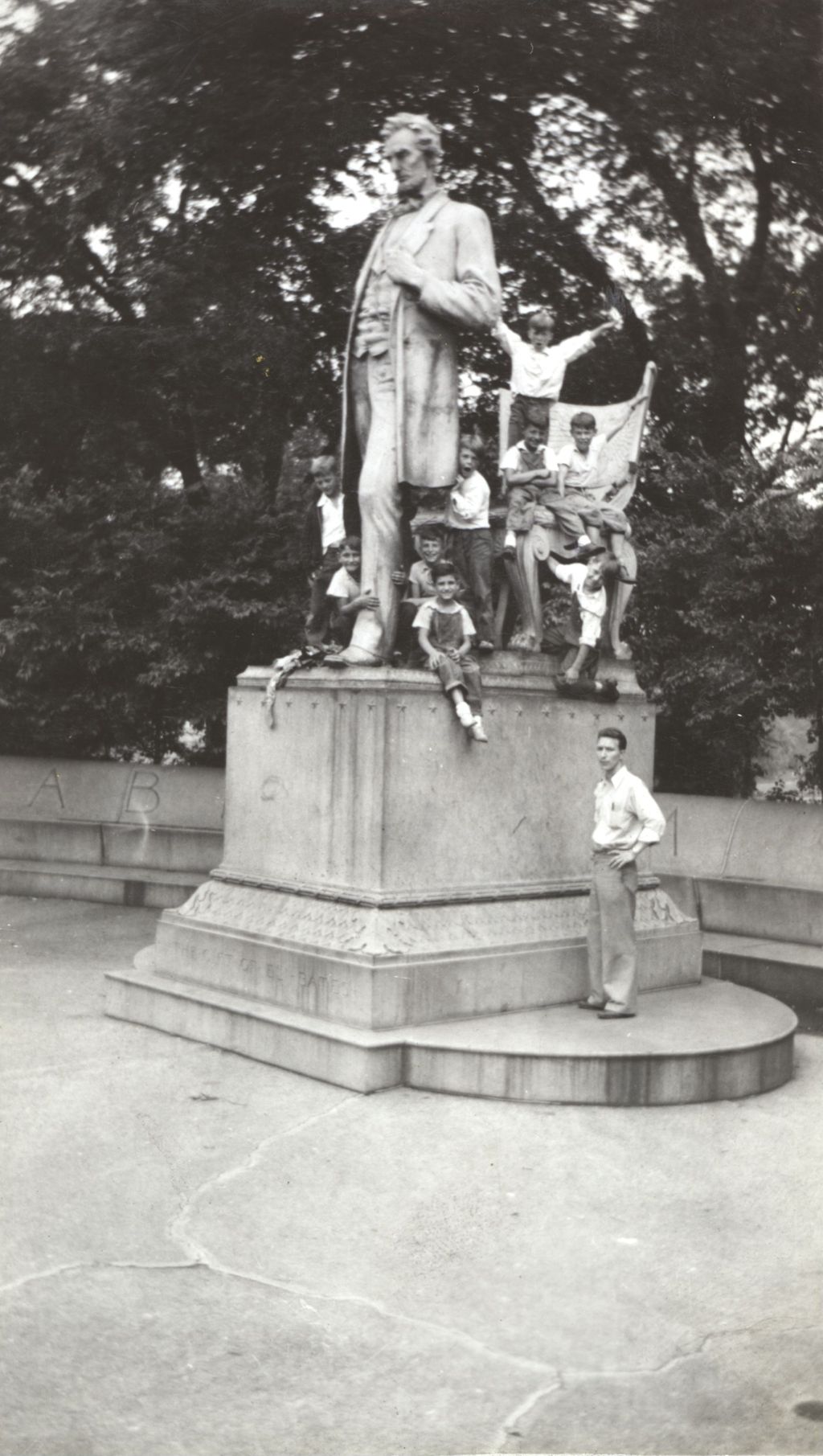 Boys climbing statue of Abraham Lincoln