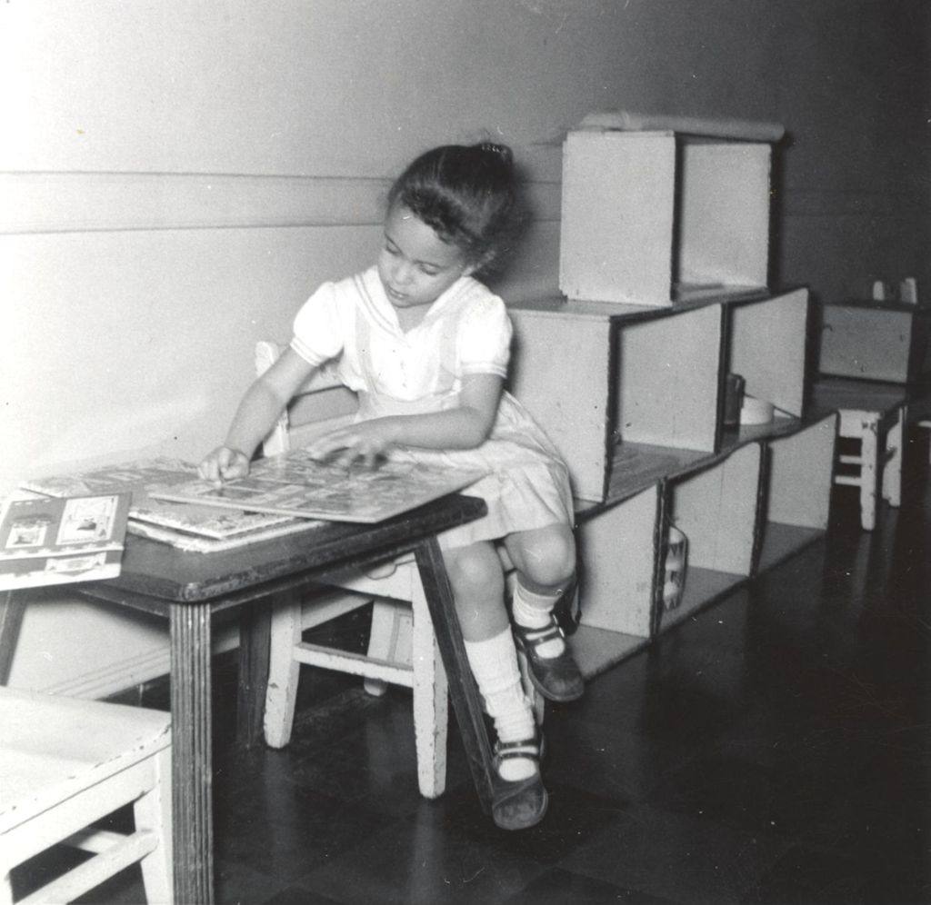 Young girl reading an oversized book