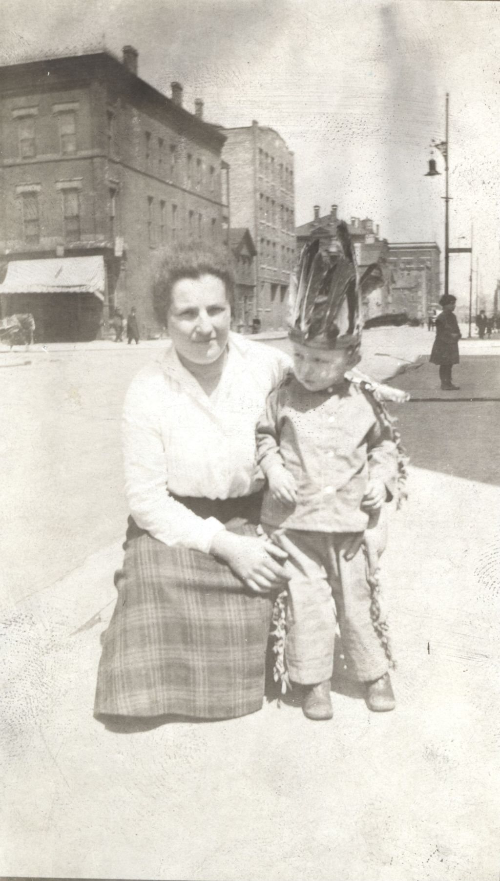 Woman with a boy in an American Indian costume