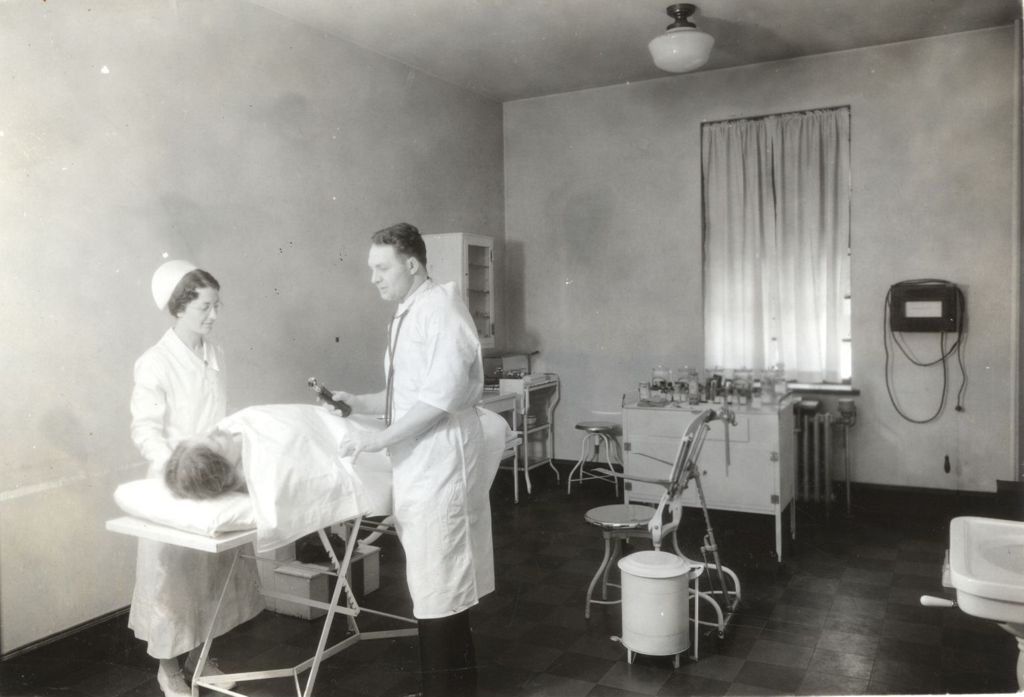 Doctor and nurse examining a woman on a gurney