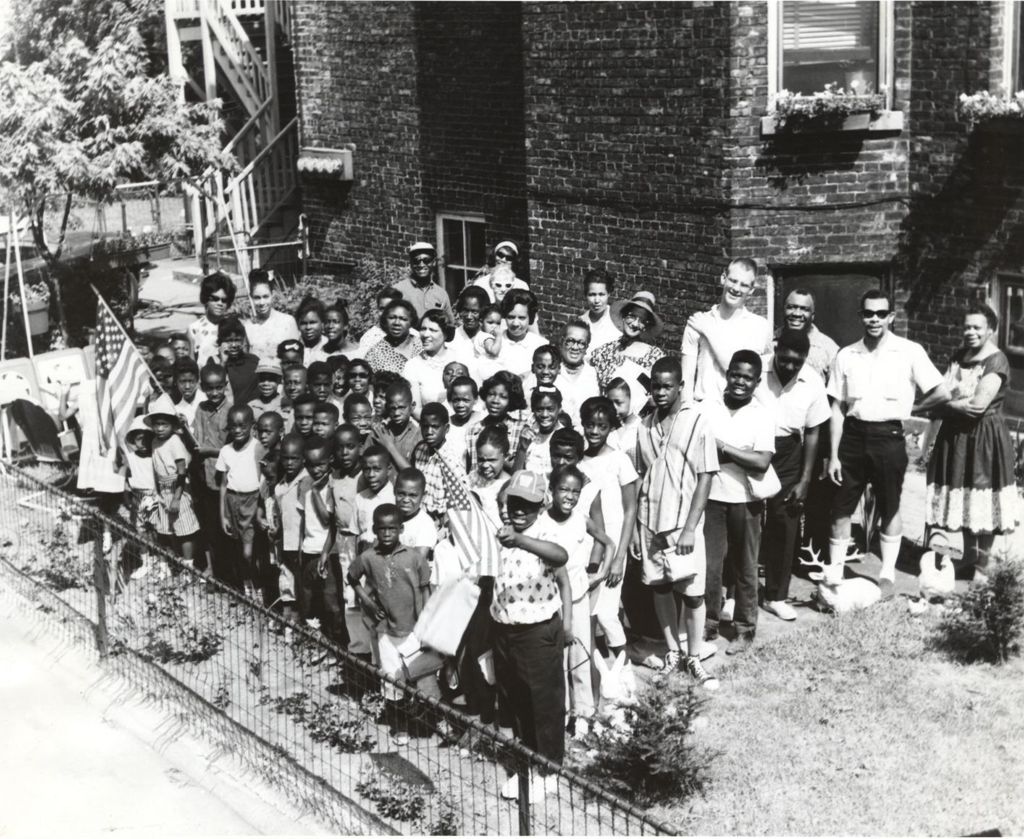 Group of children and adults outside a building