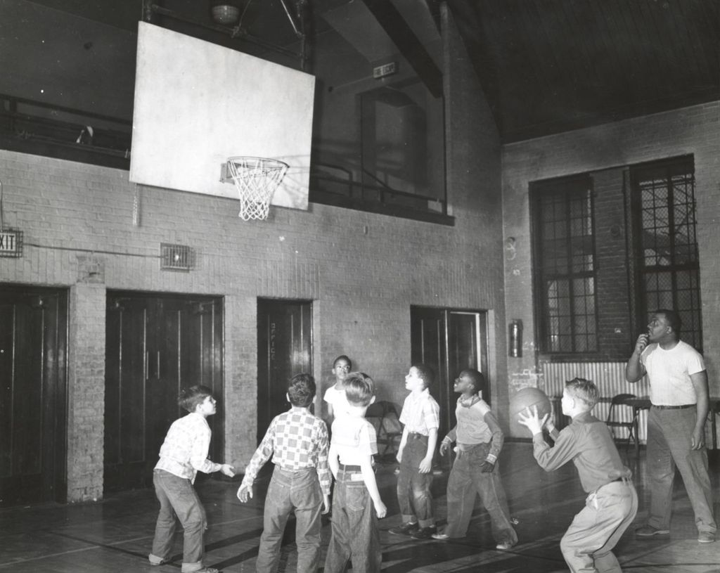 Boys playing basketball at Marcy Center gymnasium