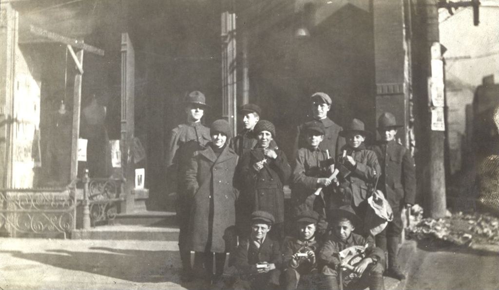 Group of boys in scouting uniforms outside a building