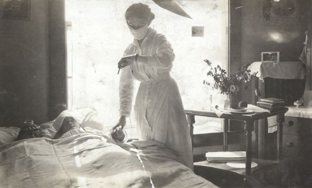 Nurse taking the pulse of sick child in a clinic bed