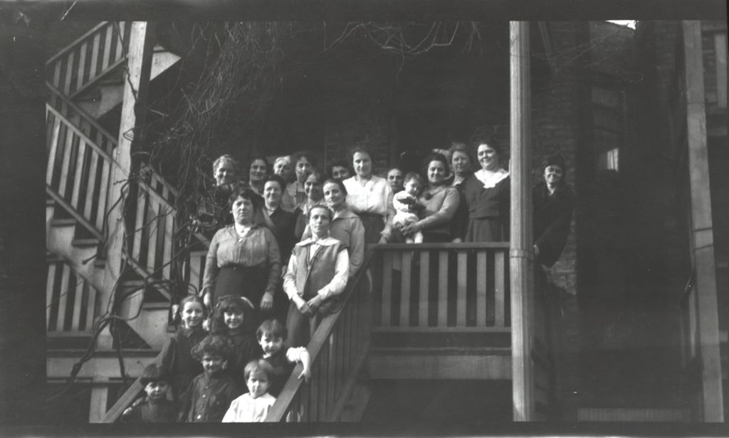 Women and children on back stairs of building