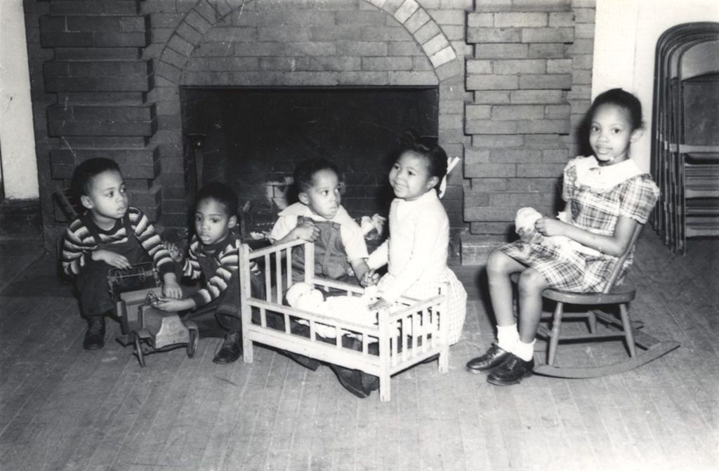 Five African American children playing with toys