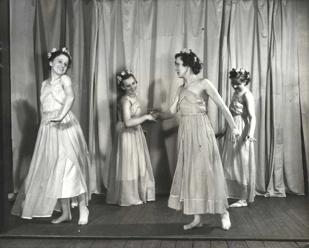 Women in costumes dancing on stage