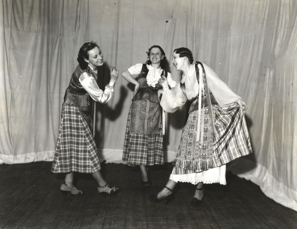 Women in folk costumes dancing on stage