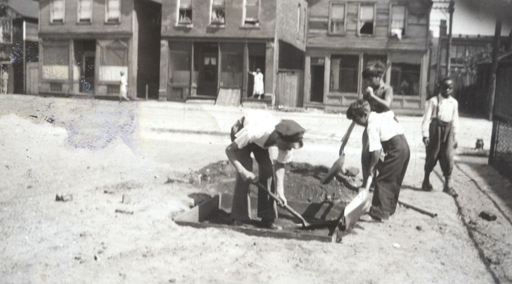 Boys digging a hole for a sandbox