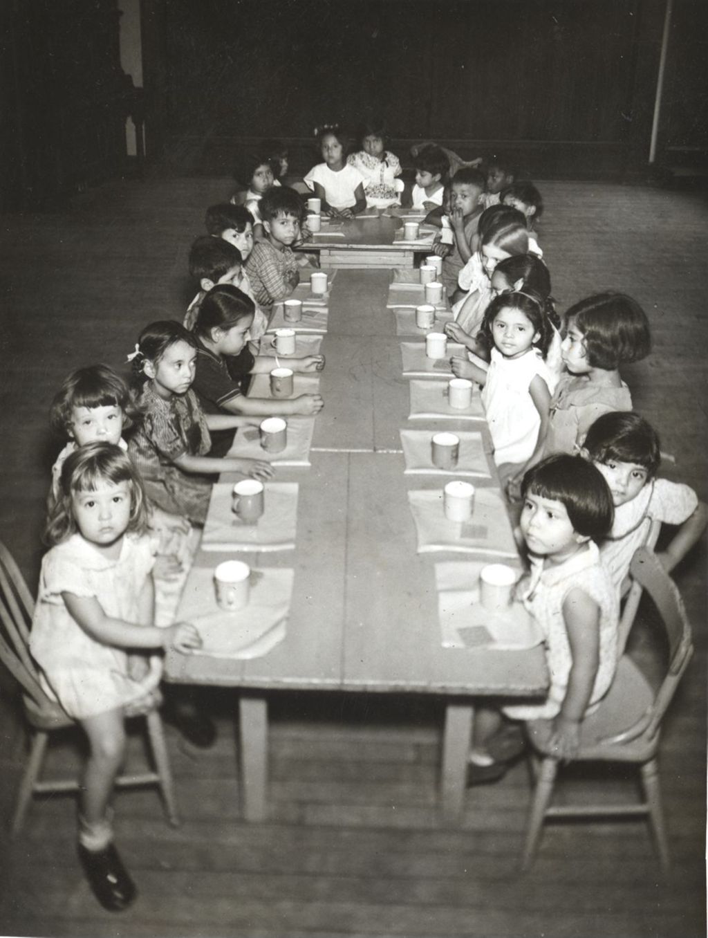Children seated at table waiting for a meal