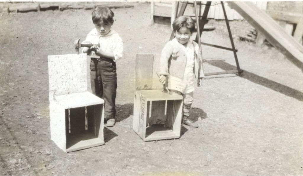 Kindergarten boys with hammers and chairs