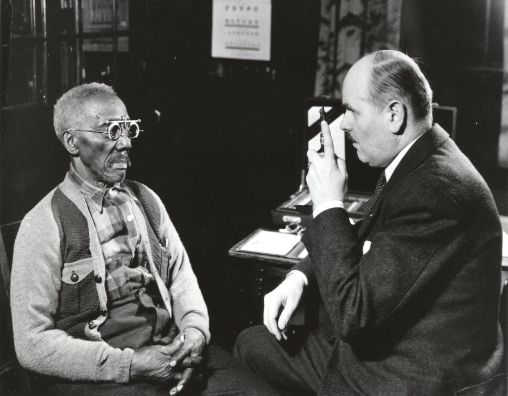 Dr. Booth doing an eye examination on a patient