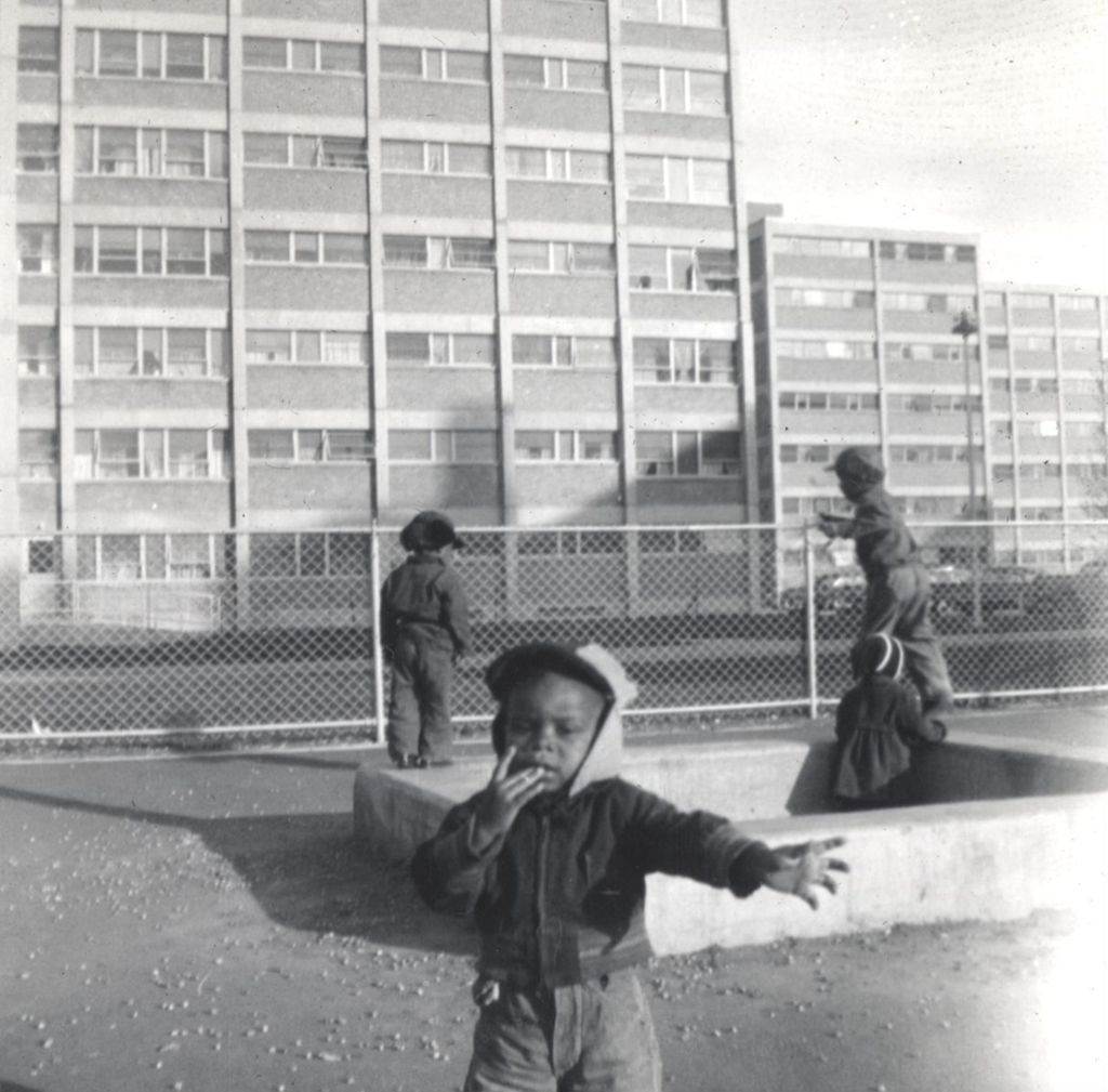 Young children playing outside of Public Housing building