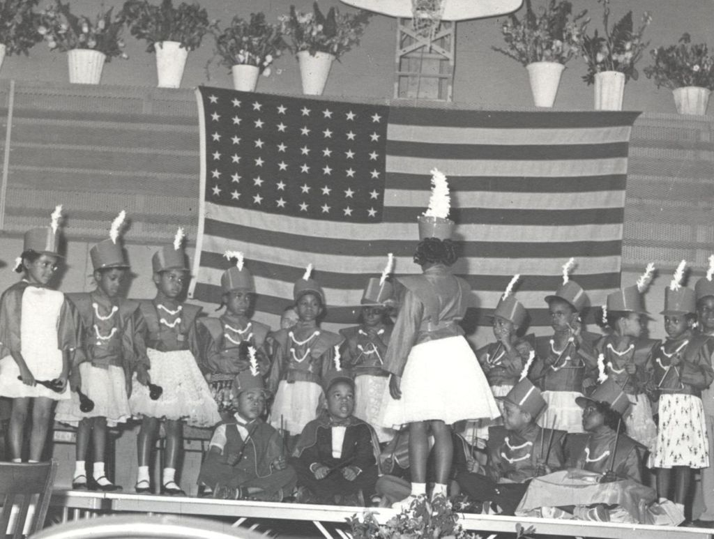 Costumed children performing in a patriotic pageant