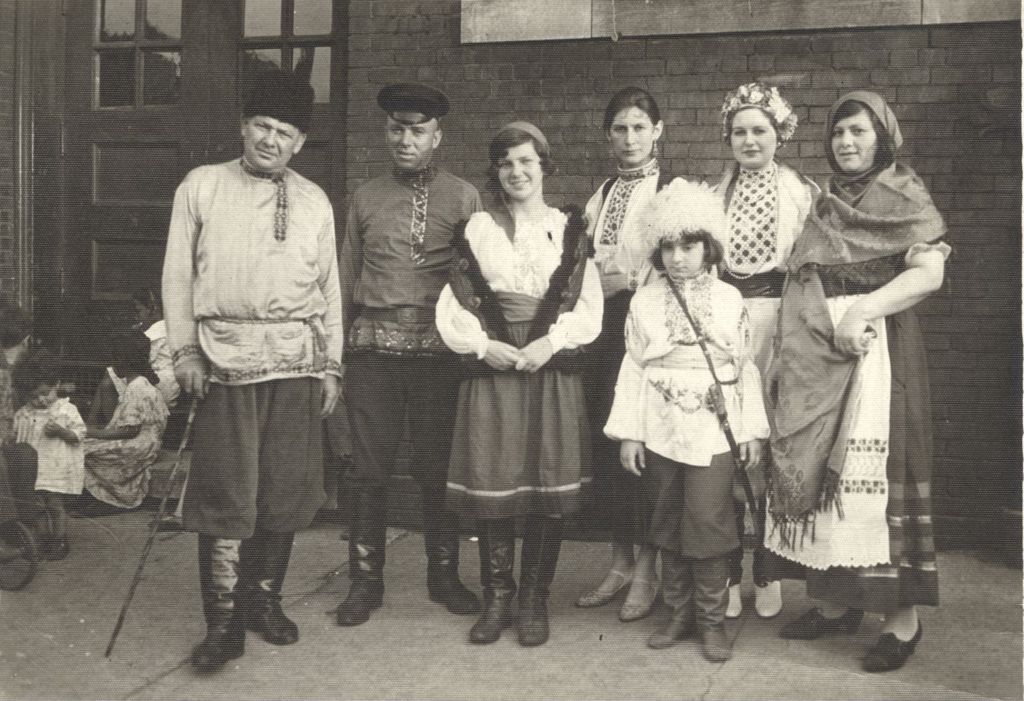 Adults and a child wearing traditional ethnic clothing
