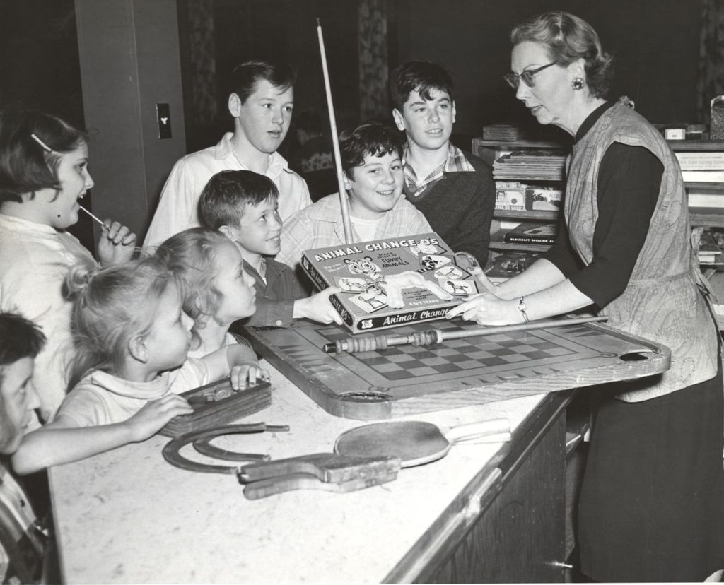Miniature of Eleanor Mathieu hands out games at the game room counter