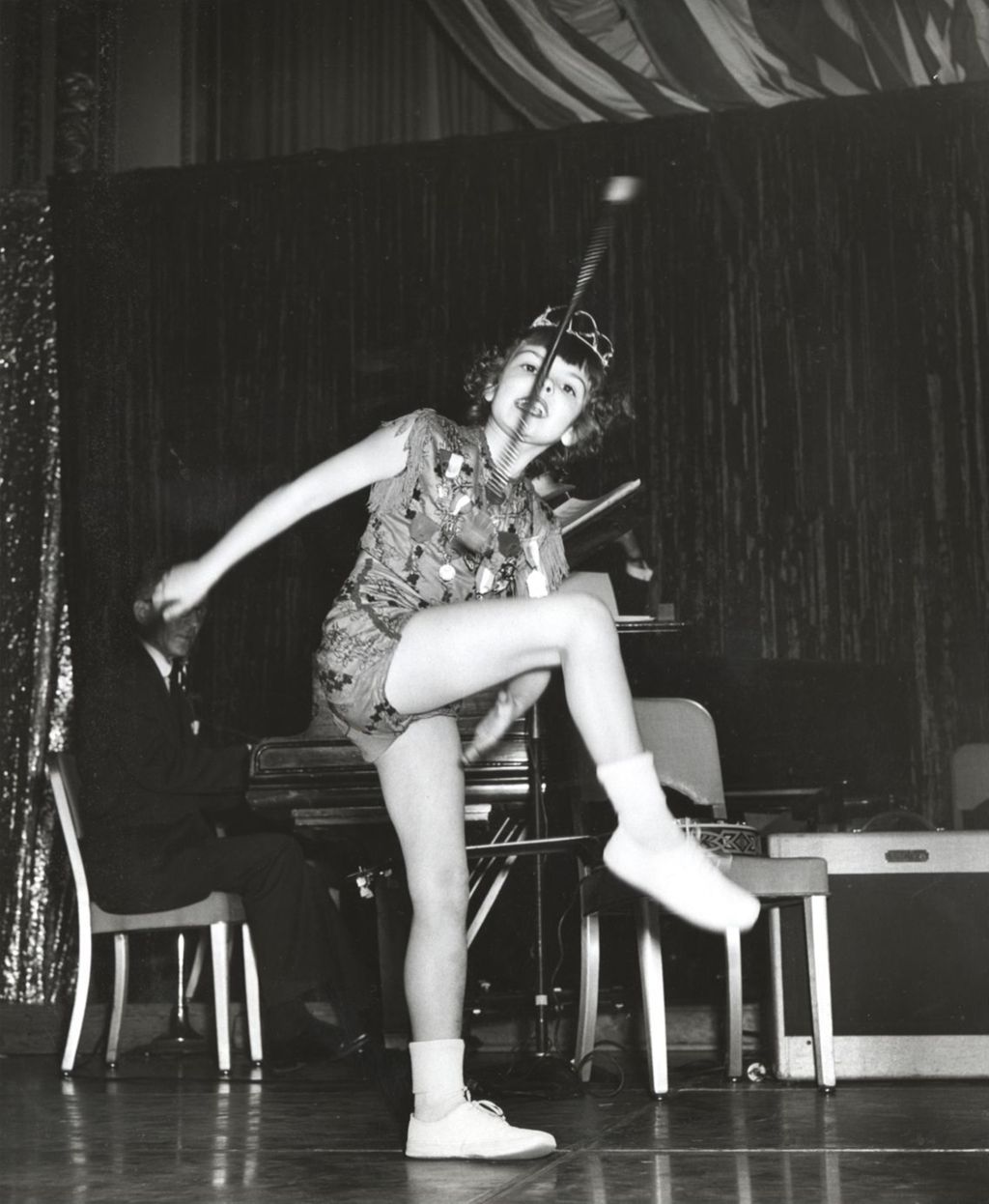 Linda Crane twirling a baton on stage