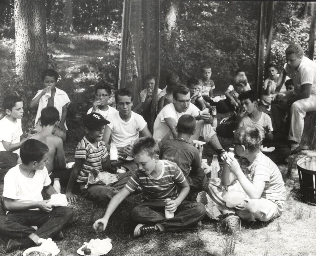 Boys eating outdoors at camp