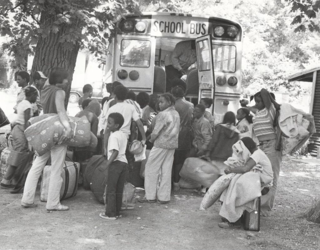 Group of children boarding a bus at camp